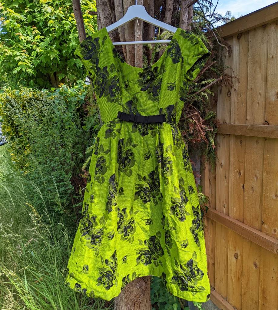 An acid green dress with black roses on it