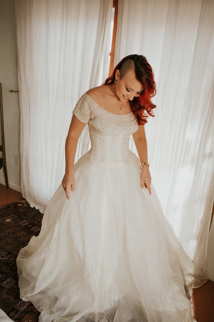 Honor in an ivory wedding dress with an off-the-shoulder neckline, boned bodice and beading